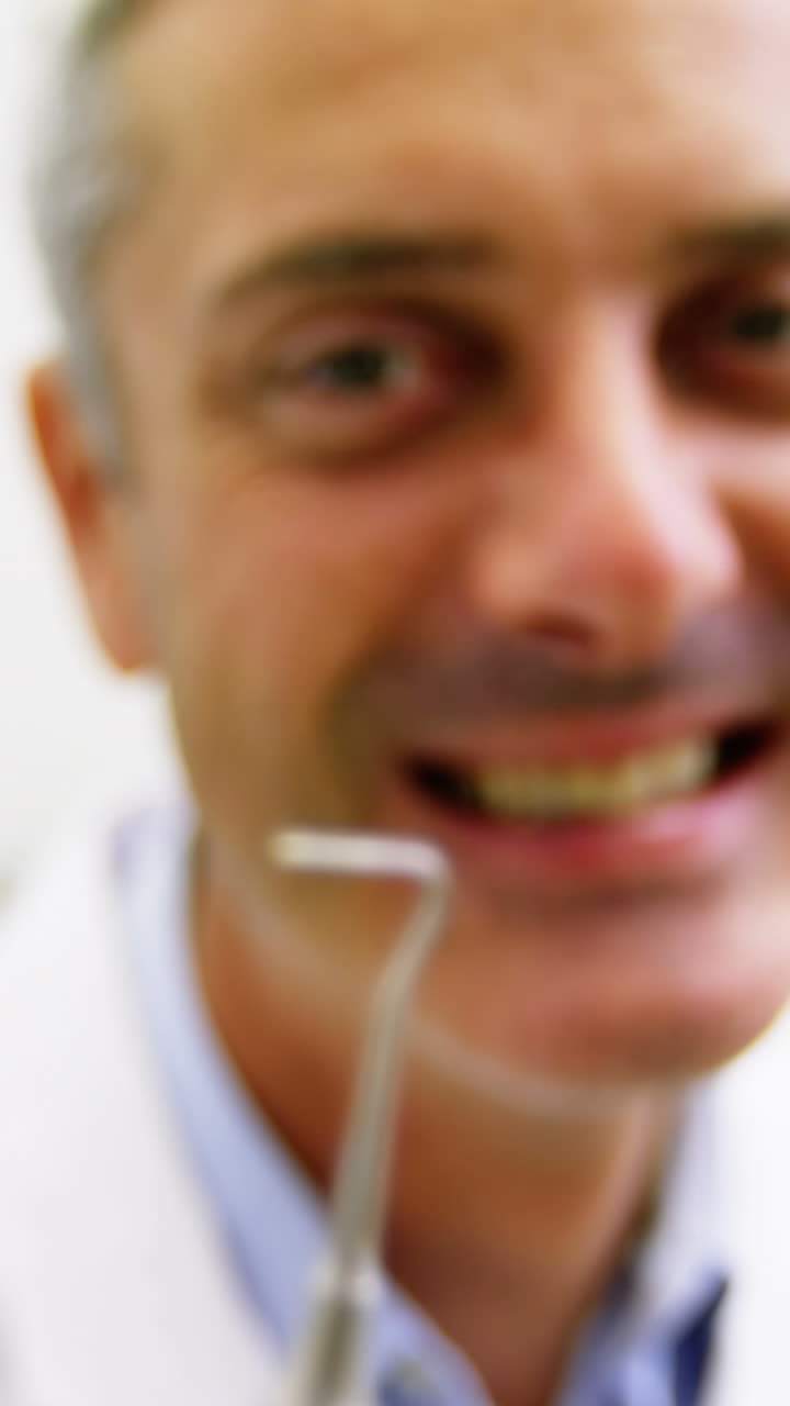 Dentist holding dental tool