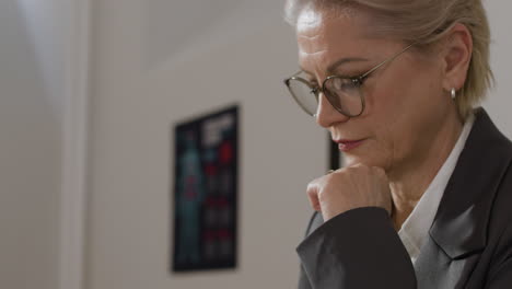 businesswoman contemplating at her desk