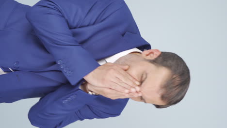 Vertical-video-of-Coughing-businessman.