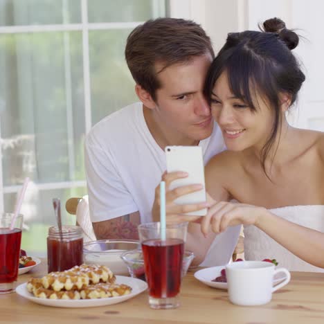 Happy-mixed-race-couple-taking-selfie