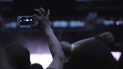 a slow motion of two men in the crowd at an open air concert