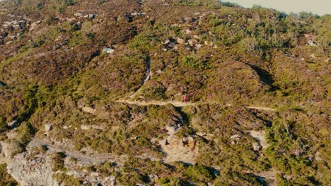 Tracking-Shot-Of-Friends-Hiking-Together-In-Heart-Of-Mountains-On-Foz-Do-Lizandro-Beach,-Portugal