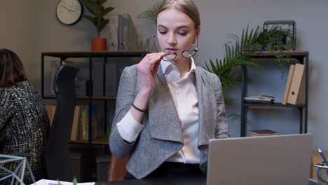 young business woman freelancer concentrated developing new project while looking on laptop screen