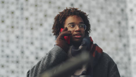 man talking on phone outdoors in winter