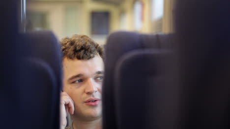 man talking on the phone in train