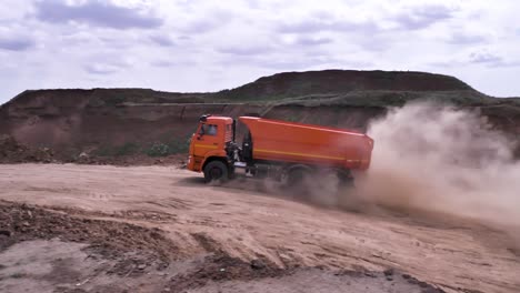 orange dump truck in a quarry