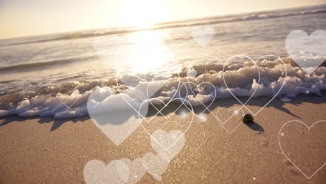 animation of hearts moving over diverse couple in love on beach in summer