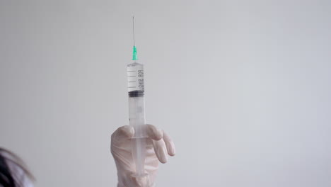 close up of doctor hand holding a syringe with a vaccine