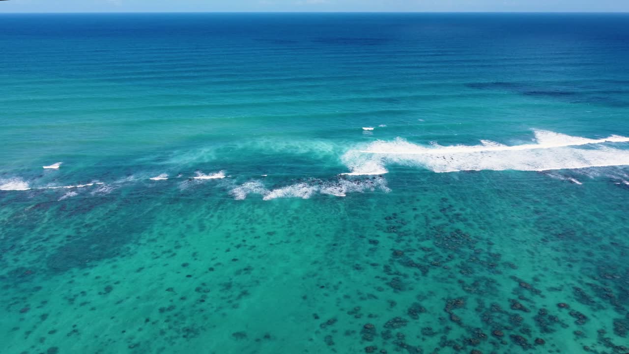 AERIAL Shot of the Waves Crashing on the Vast Coral Reefs of Oahu, Hawaii