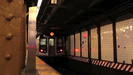 a subway train pulls out of a station in new york city