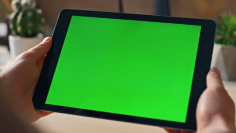 freelancer hands holding tablet working remote at home close up. mockup monitor