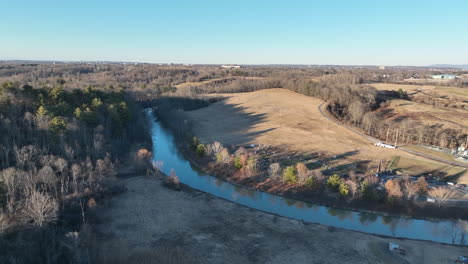 early spring landscape of a valley with parks and limited buildings in the background