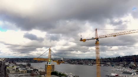 Bird's-perspective-of-construction-cranes-on-a-cloudy-but-bright-day