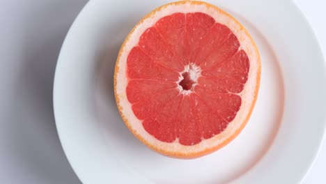 ripe and juicy grapefruit. red grapefruit on white background. focus in the middle