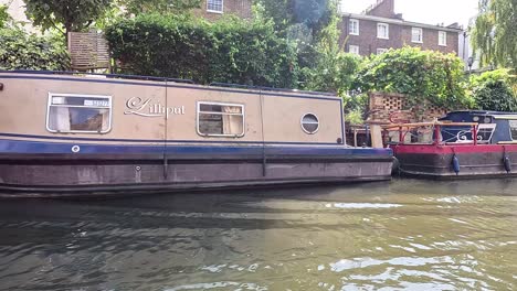 two narrowboats passing by in camden, london