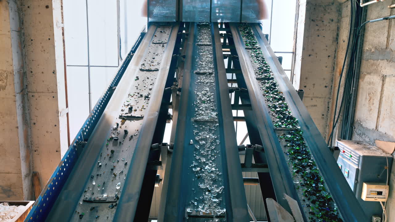 Process of sorting glass garbage on a conveyor belt at waste sorting plant