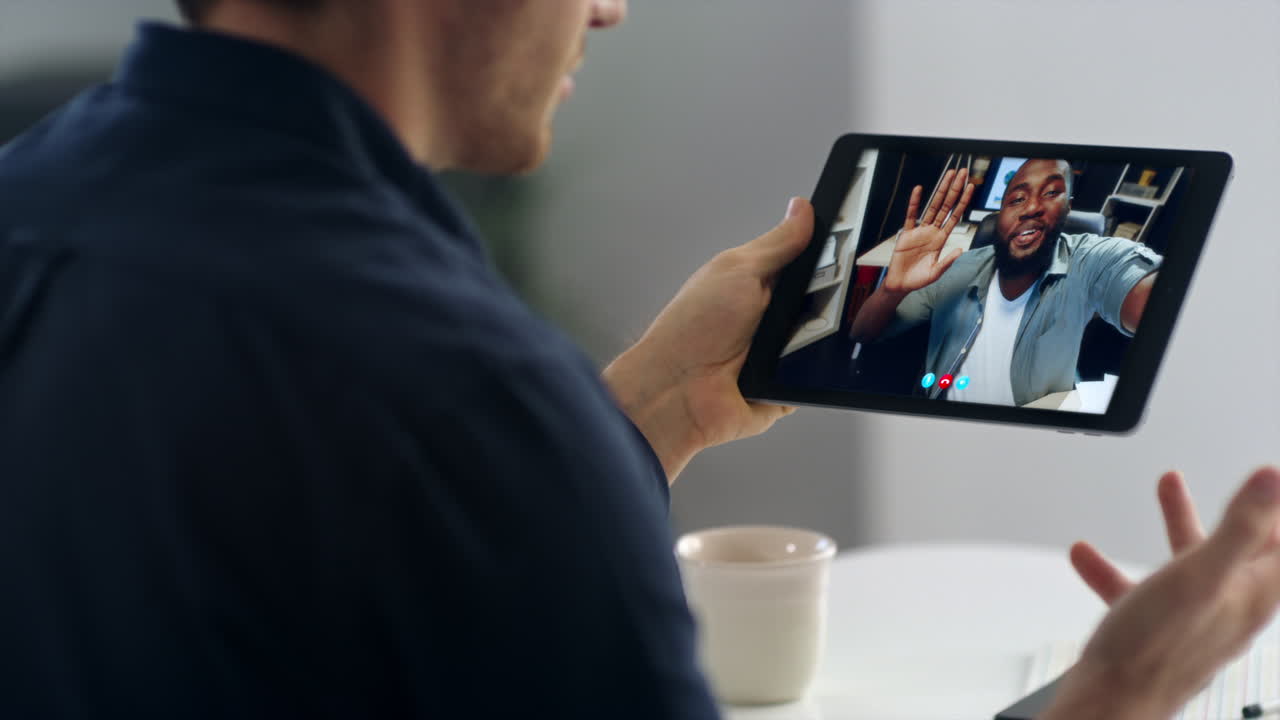 Tablet freelancer virtual meeting with colleague close up