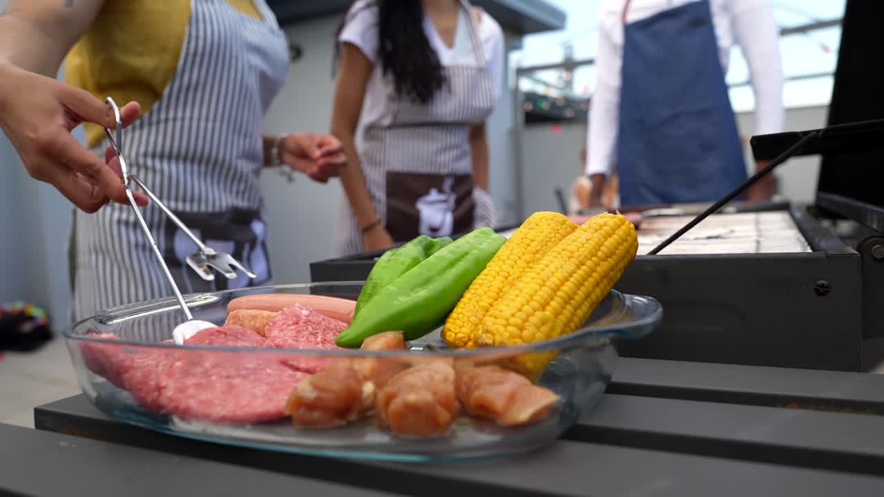 People enjoying a barbecue with meat and vegetables