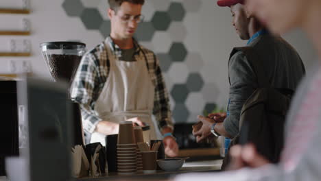 happy businessman cashier working in busy cafe barista serving customers buying coffee using credit card supporting small business enjoying friendly service successful startup shop