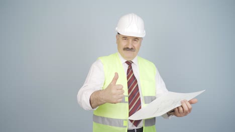 Engineer looking at camera and making positive gesture.