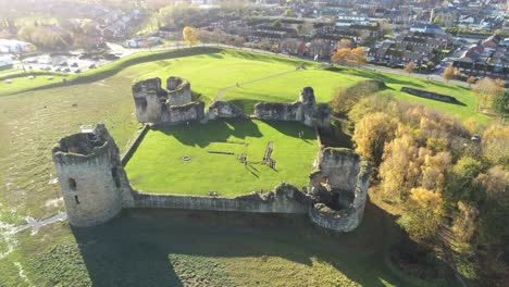 historical flint castle medieval military ruins landmark aerial birdseye view orbit left with flares