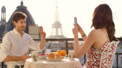 a-young-couple-having-breakfast-on-the-balcony