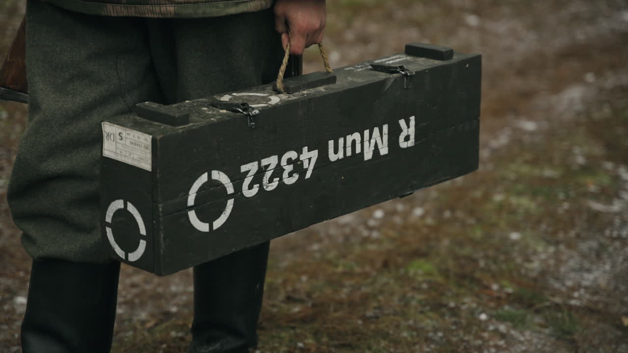 WWII Soldier carrying ammunition box