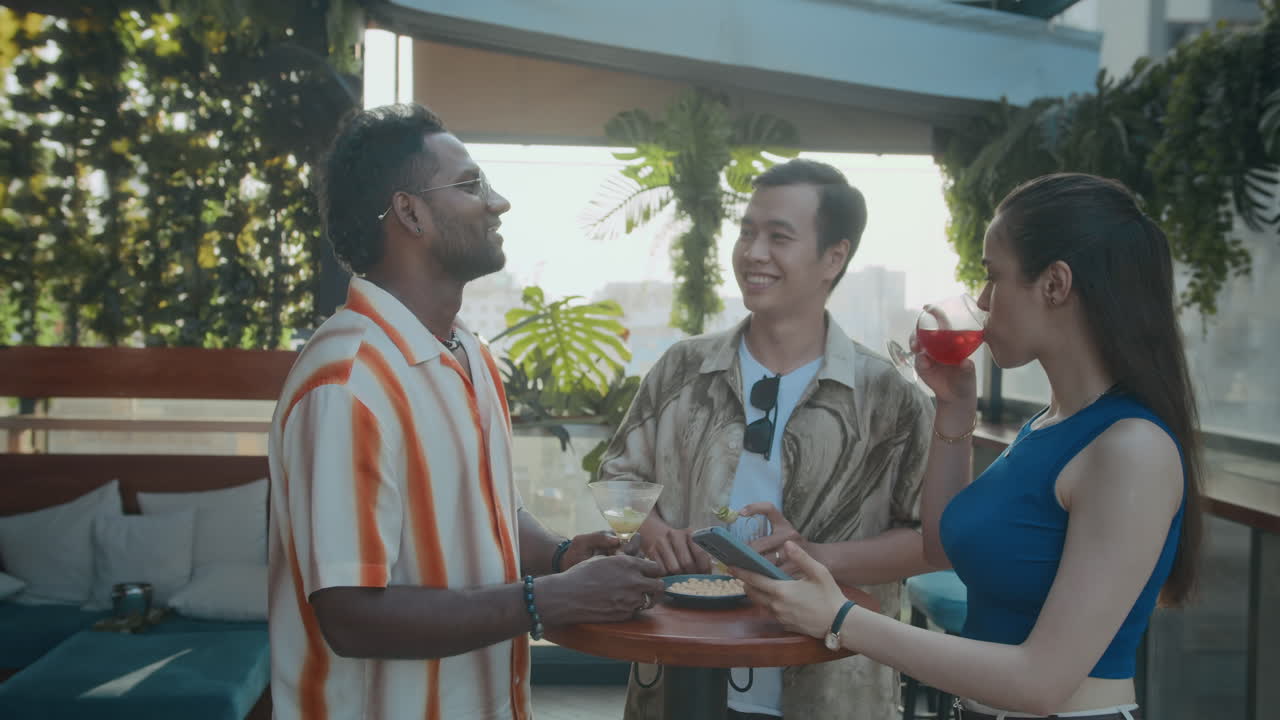 Three Diverse People Taking Selfie at Bar on Smartphone