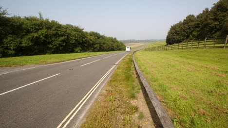 Wide-shot-looking-down-Carsington-water-dam-with-the-dam-road-and-traffic