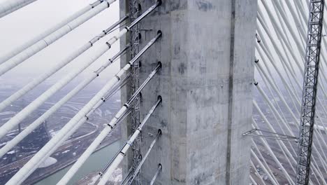 close-up of suspension cables and concrete tower on gordie howe bridge in winter