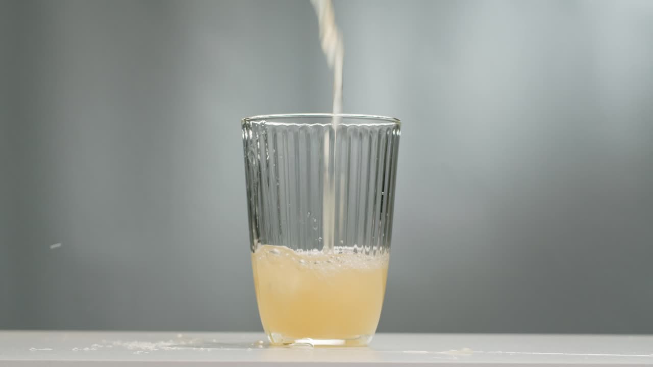 Orange or white wine bottle and glass, spanish french apple cider pouring, pouring of ecological natural wine.