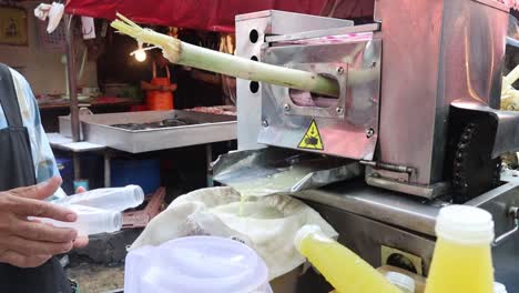 vendor extracting fresh sugar cane juice