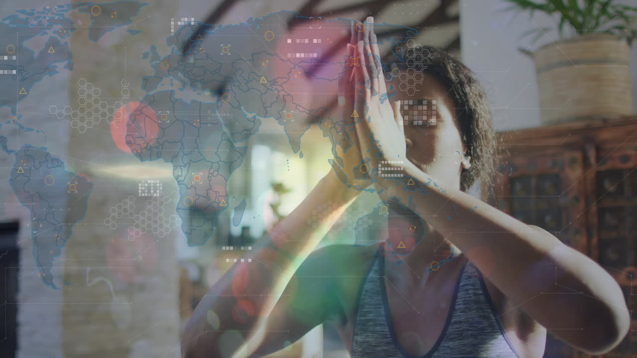 woman practicing yoga at home, displaying health technology interface with world map graphics