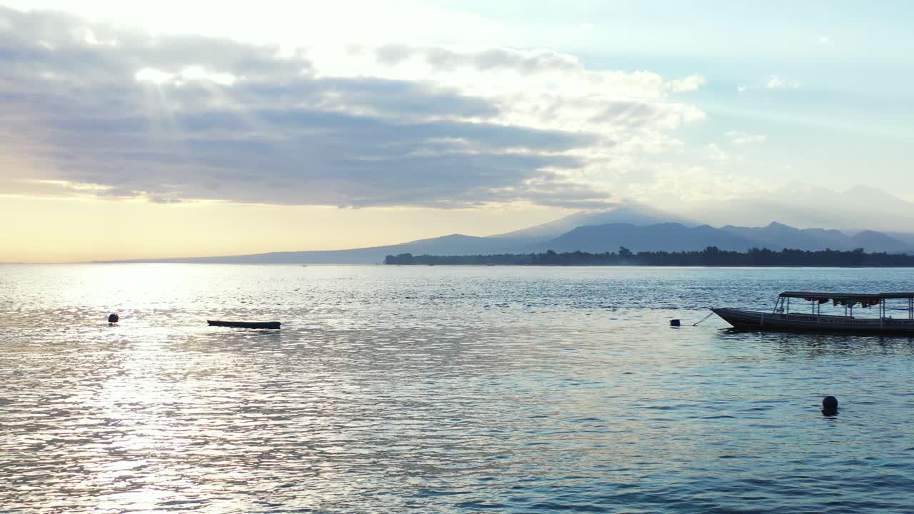 Beautiful scenery of rippling water reflecting the sunlight during the late afternoon with mountains in the distance