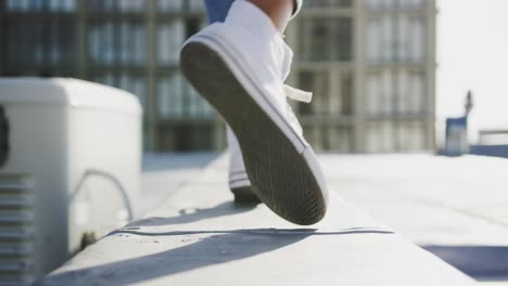 Legs-of-fashionable-young-woman-walking-on-urban-rooftop