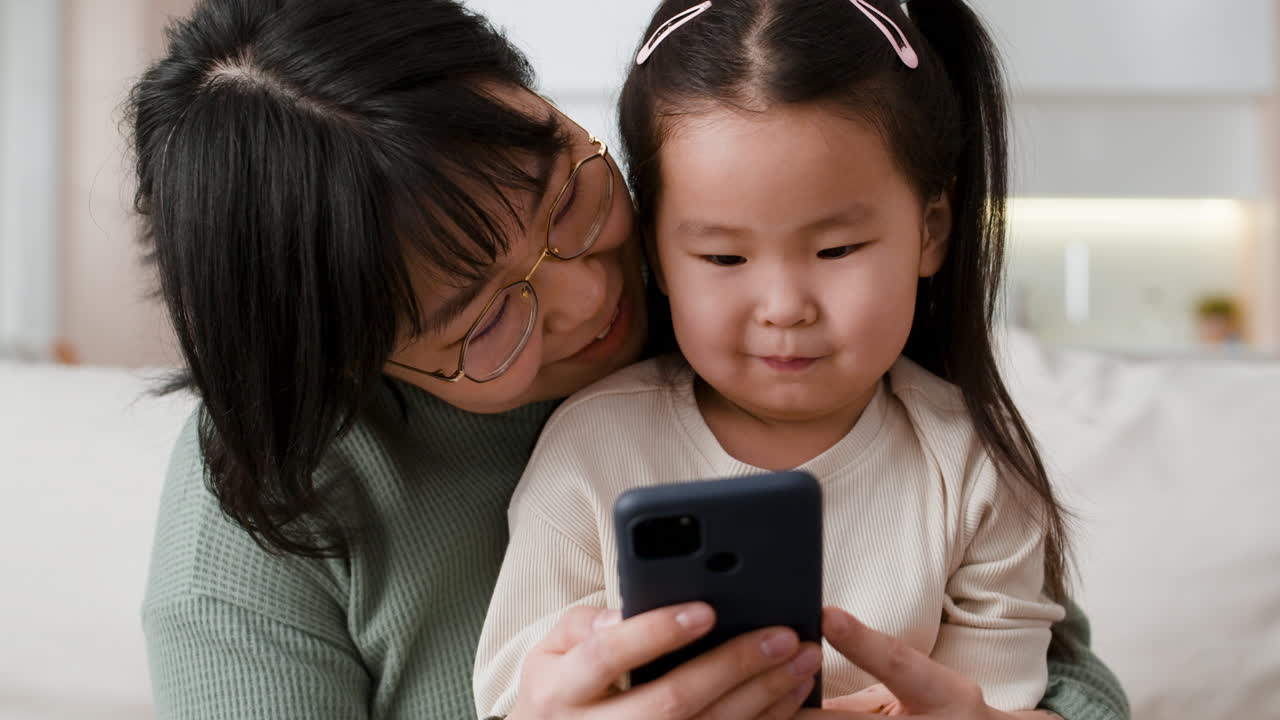 Mother and daughter using a smartphone