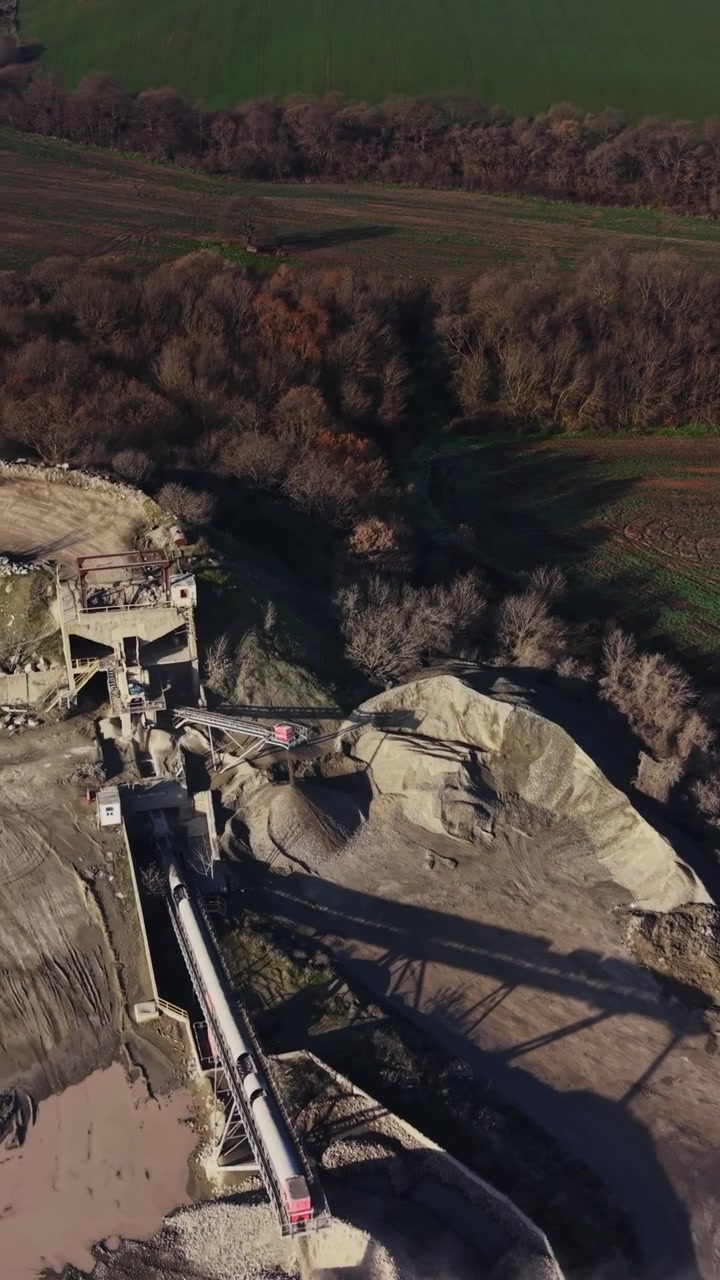 Quarry site shows machinery and land in use for mining operations