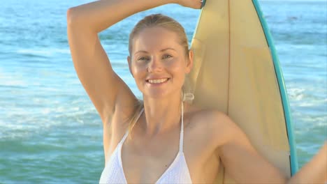 woman holding her surfboard