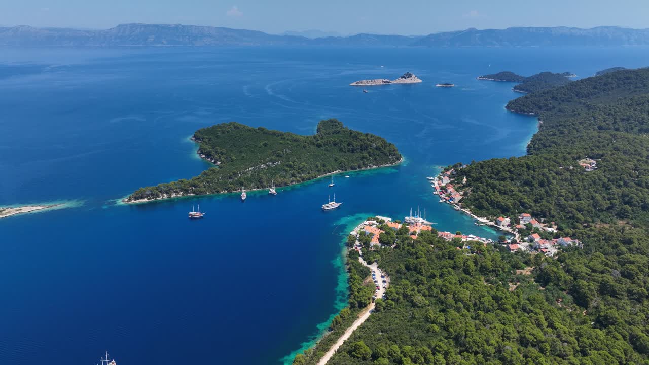 Boats Off Coast of Mljet Island in Blue Adriatic Sea in Croatia AERIAL