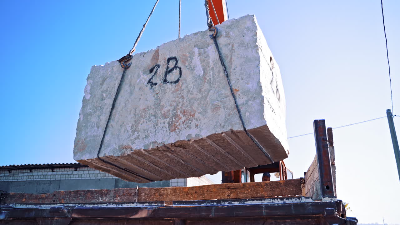 Blocks of marble in quarry. Industrial view of crane loading marble