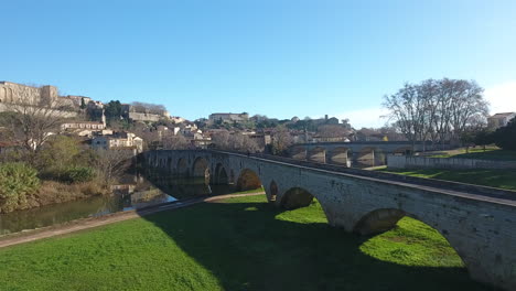 Green-grass-and-old-ancient-bridge-in-Beziers-herault-aerial-view