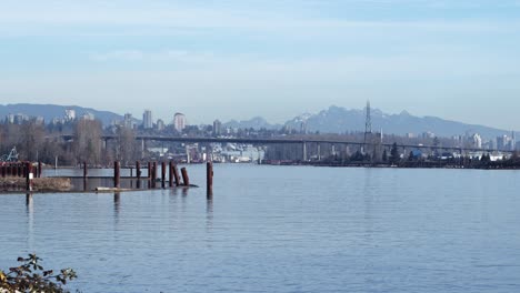 cityscape,-cars-passing-over-bridge-and-river-inlet--timelapse