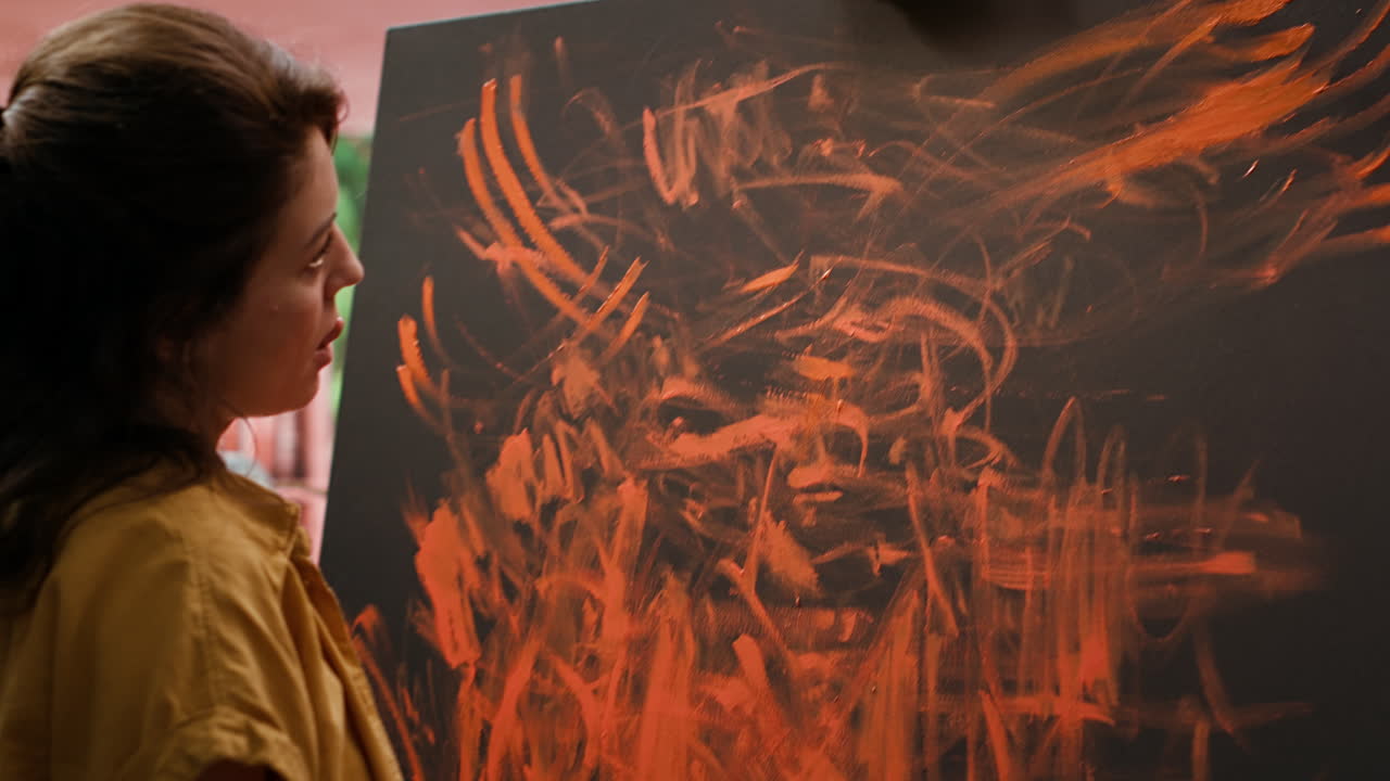 Woman painting abstract art on canvas