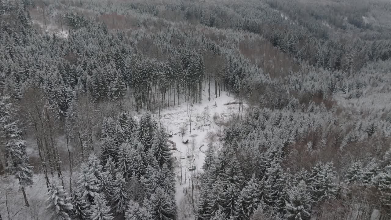 Aerial view of an ancient village with wooden houses. An ancient way of life in the deep wilderness of snowy forests. Drone winter shot