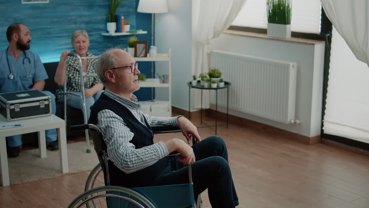 Invalid old man receiving medical visit from woman nurse