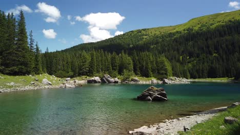 Time-lapse-with-camera-panning-of-the-blue-colored-Obernberger-Lake-in-Tyrol,-Austria