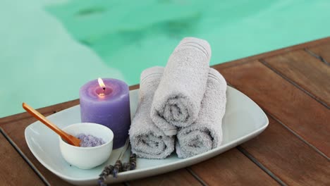 beauty treatment in bowl presented on plate with candle