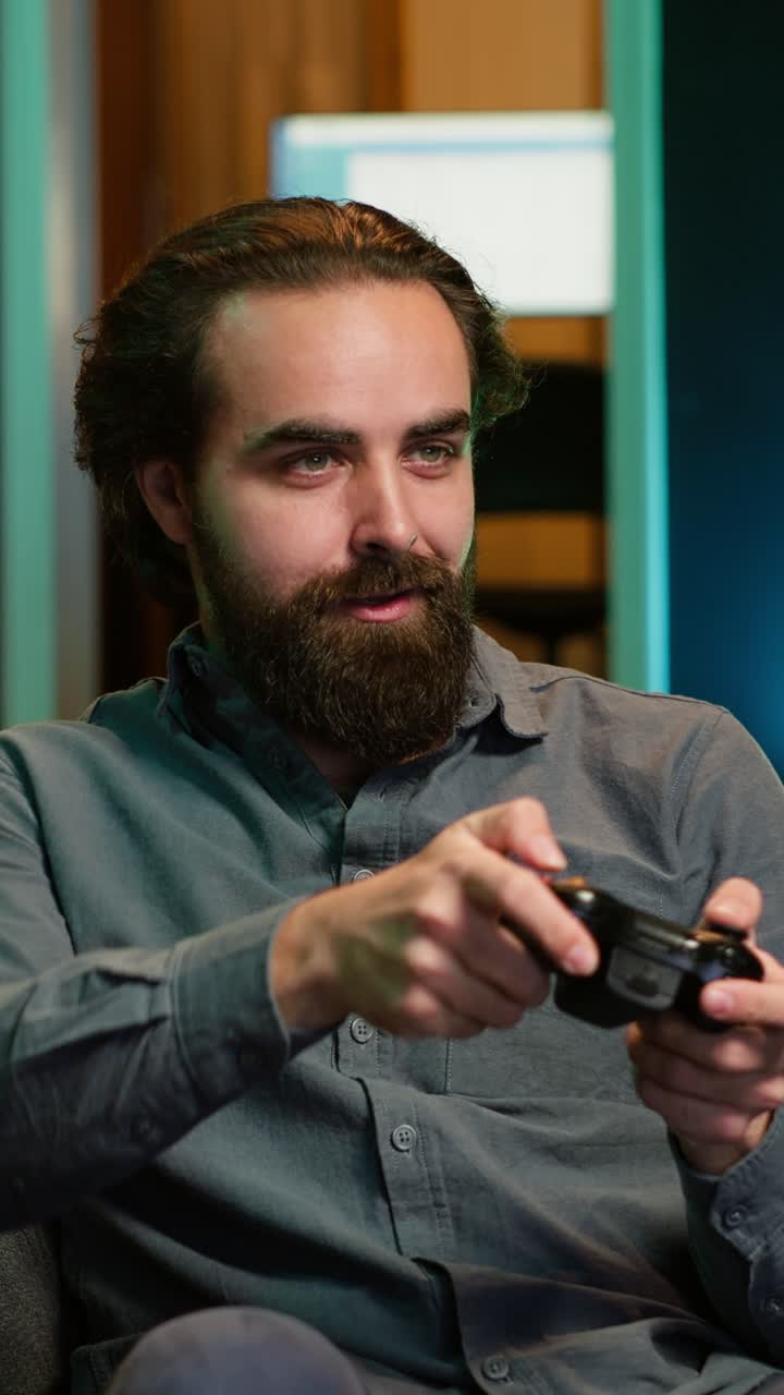 Vertical video Happy gamer at home gaming and enjoying leisure time