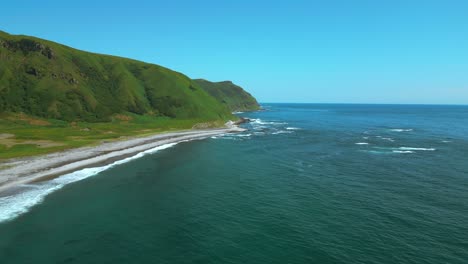 coastal landscape with lush green hills and rocky shore