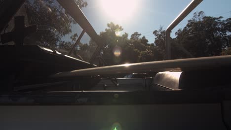 nose of surfboard coming into shot as loaded onto landrover